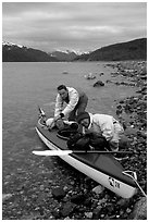 Kayaker packing tight into a double kayak. Glacier Bay National Park, Alaska (black and white)