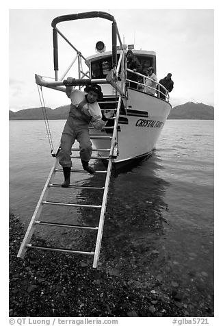 Kayaker comes down Glacier Bay Lodge concession boat for a drop-off. Glacier Bay National Park, Alaska