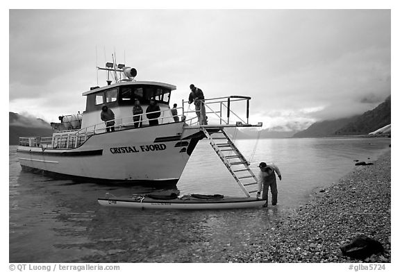 Kayaker retrieving kayak after drop-off. Glacier Bay National Park, Alaska