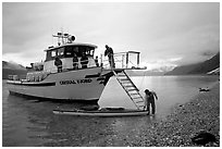 Kayaker retrieving kayak after drop-off. Glacier Bay National Park, Alaska (black and white)