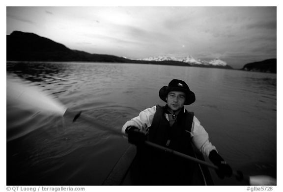 Kayaker paddling in Muir Inlet at midnight. Glacier Bay National Park, Alaska