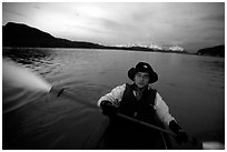 Kayaker paddling in Muir Inlet at midnight. Glacier Bay National Park, Alaska (black and white)