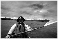 Kayaker paddling in Muir Inlet. Glacier Bay National Park, Alaska (black and white)