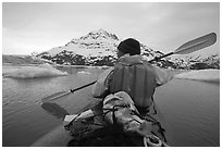 Kayaker paddling amongst icebergs near John Hopkins Inlet. Glacier Bay National Park, Alaska (black and white)