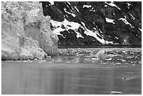 Kayaker paddling away from Lamplugh Glacier. Glacier Bay National Park, Alaska (black and white)