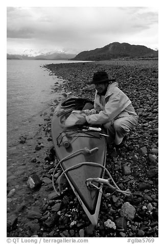 Kayaker unloading kayak. Glacier Bay National Park, Alaska