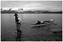 Kayaker towing kayak, East arm. Glacier Bay National Park, Alaska (black and white)