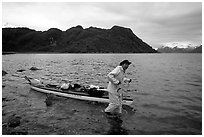 Kayaker towing kayak, East arm. Glacier Bay National Park, Alaska (black and white)