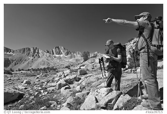 Hikers looking at map and pointing, Dusy Basin. Kings Canyon National Park, California