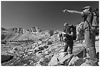 Hikers looking at map and pointing, Dusy Basin. Kings Canyon National Park, California (black and white)