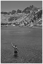 Man standing in alpine lake, lower Dusy Basin. Kings Canyon National Park, California (black and white)
