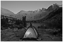 Tent with light and Palisades at dusk, lower Dusy Basin. Kings Canyon National Park, California (black and white)