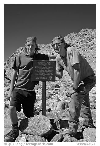 Father and son standing next to Bishop Pass sign. Kings Canyon National Park, California