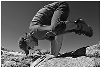 Hiker balancing on hands on rock, Bishop Pass. Kings Canyon National Park, California (black and white)