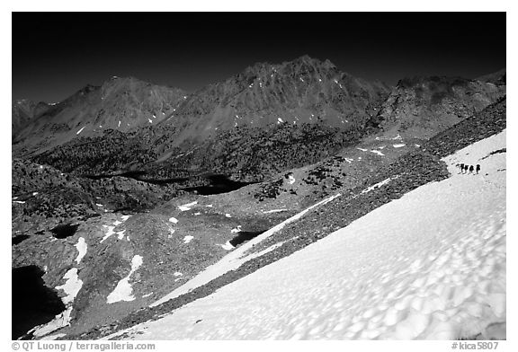 Backpackers on a snow field at a high pass. Kings Canyon National Park, California