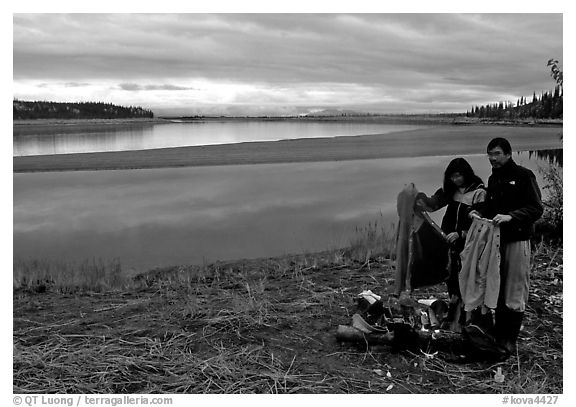 Canoeist drying out clothing over a campfire. Kobuk Valley National Park, Alaska