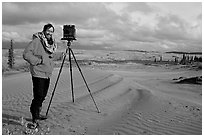 Large format photographer with camera on Kobuk Dunes. Kobuk Valley National Park, Alaska (black and white)