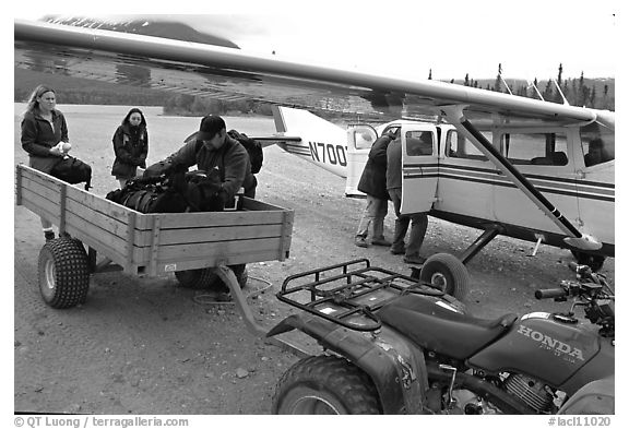 Unloading the gear from the plane to a trailer on the Port Alsworth airstrip. Lake Clark National Park, Alaska