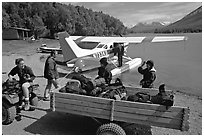 Getting ready to load the floatplane with the backpacking gear. Lake Clark National Park, Alaska (black and white)