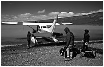 Backpackers dropped off by floatplane on Lake Turquoise. Lake Clark National Park, Alaska (black and white)