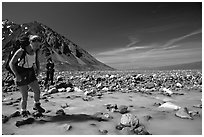 Hiker crossing a stream next to Lake Turquoise. Lake Clark National Park, Alaska (black and white)