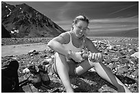 Hiker drying out socks after a stream crossing. Lake Clark National Park, Alaska (black and white)