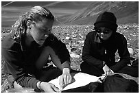 Women hikers consulting a map. Lake Clark National Park, Alaska (black and white)