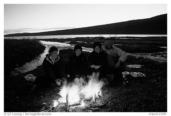 Warming toes on campfire next to Turquoise Lake. Lake Clark National Park, Alaska