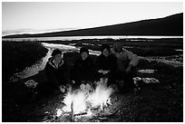 Warming toes on campfire next to Turquoise Lake. Lake Clark National Park, Alaska (black and white)