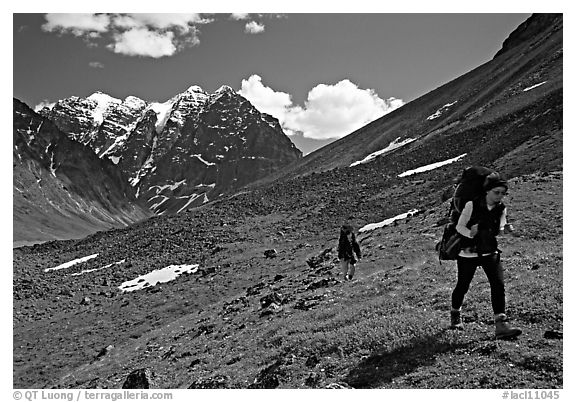 Backpackers walking on a slope. Lake Clark National Park, Alaska