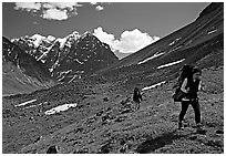 Backpackers walking on a slope. Lake Clark National Park, Alaska (black and white)