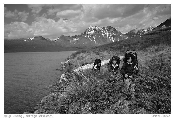 Backpackers travelling cross-country on the shore of Turquoise Lake. Lake Clark National Park, Alaska