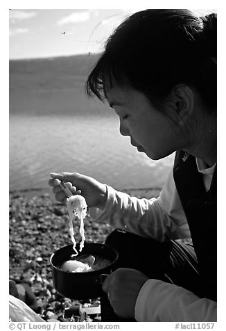 Backpacker eating noodles from a camp pot. Lake Clark National Park, Alaska