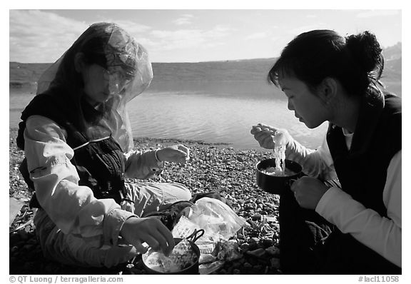 Backpackers eating noodles from a camp pot. Lake Clark National Park, Alaska