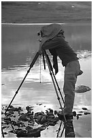 Large format photographer under dark cloth on the shores of Turquoise Lake. Lake Clark National Park, Alaska (black and white)