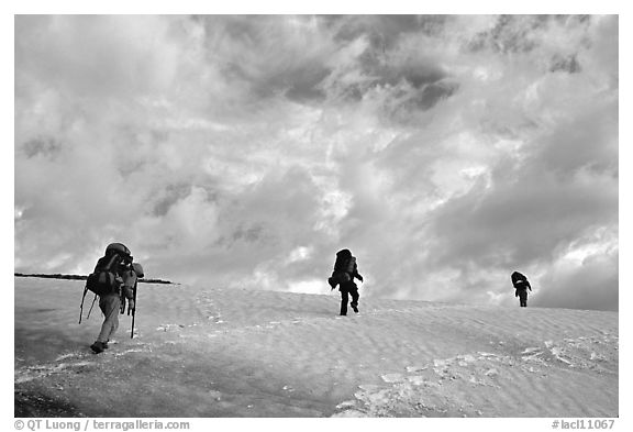 Backpackers crossing a neve. Lake Clark National Park, Alaska