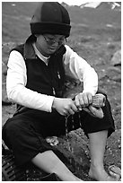 Woman backpacker drying socks after a stream crossing. Lake Clark National Park, Alaska (black and white)