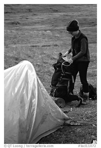 Backpacker unpacking backpack into the tent. Lake Clark National Park, Alaska