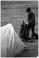 Backpacker unpacking backpack into the tent. Lake Clark National Park, Alaska (black and white)