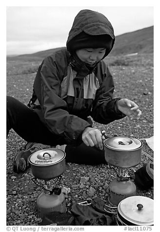 Backpacker cooks meal on gas campstove. Lake Clark National Park, Alaska