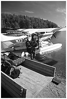 Backpackes being unloaded from floatplane in Port Alsworth. Lake Clark National Park, Alaska (black and white)