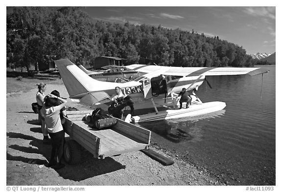 Backpackes being unloaded from floatplane to a trailer in Port Alsworth. Lake Clark National Park, Alaska