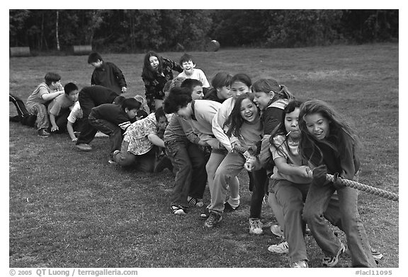 Children playing tug-of-war with a rope. Lake Clark National Park, Alaska