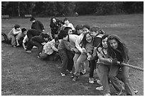 Children playing tug-of-war with a rope. Lake Clark National Park, Alaska (black and white)