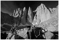 Man and woman pausing with backpacks below the East face of Mt Whitney. Sequoia National Park, California (black and white)