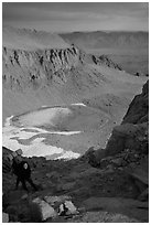 Woman on steep slope above frozen Iceberg Lake. Sequoia National Park, California (black and white)