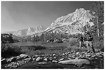 Hikers crossing stream on rocks at Long Lake, John Muir Wilderness. Kings Canyon National Park, California (black and white)