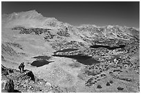 Hikers looking at view  above Saddlebag Lakes, John Muir Wilderness. Kings Canyon National Park, California (black and white)