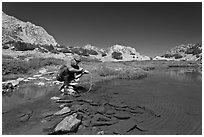 Man filtering water from stream, John Muir Wilderness. Kings Canyon National Park, California (black and white)