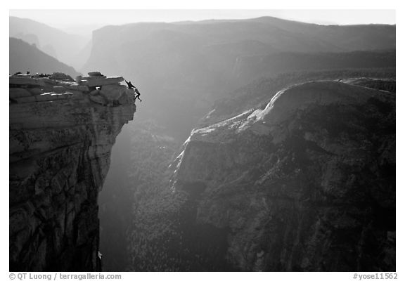 Hanging dramatically from the Jumping Board, Half-Dome. Yosemite National Park, California